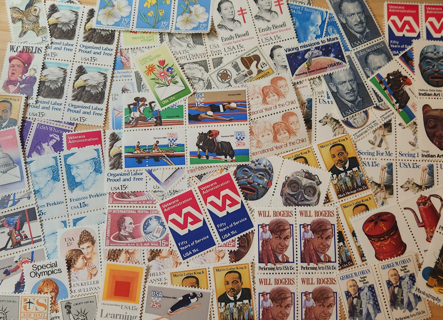 Hundred 15 cent unused postage stamps 1970s-1980s / total face value $15.00 / 30+ vintage designs